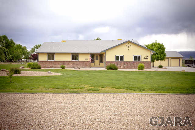 2391 H Road Grand Junction, CO 81505 - Photo 1 of 33 a front view of a house with a yard and garage