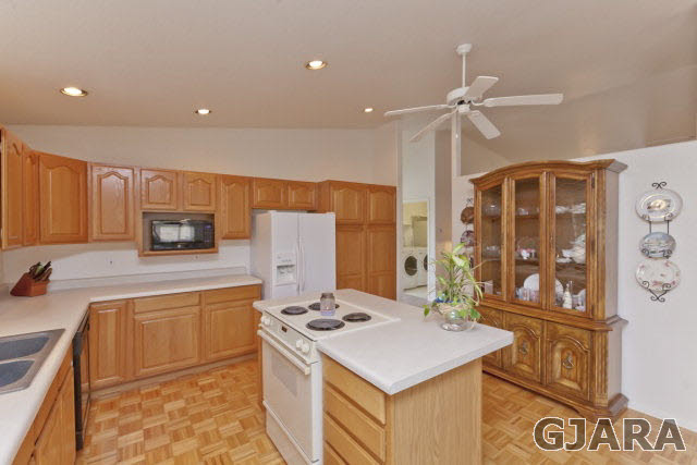 2391 H Road Grand Junction, CO 81505 - Photo 11 of 33 a kitchen with a sink a stove and a refrigerator