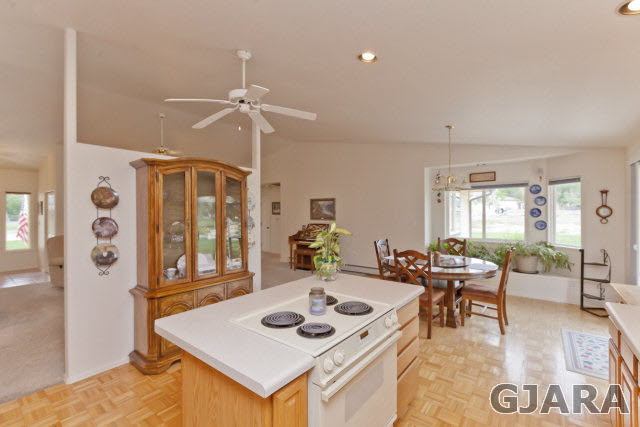 2391 H Road Grand Junction, CO 81505 - Photo 10 of 33 a living room with furniture a flat screen tv and a table