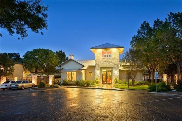 2800 Bartons Bluff Lane, Unit 2103 Austin, TX 78746 - Photo 6 of 10 a front view of a building with a garden