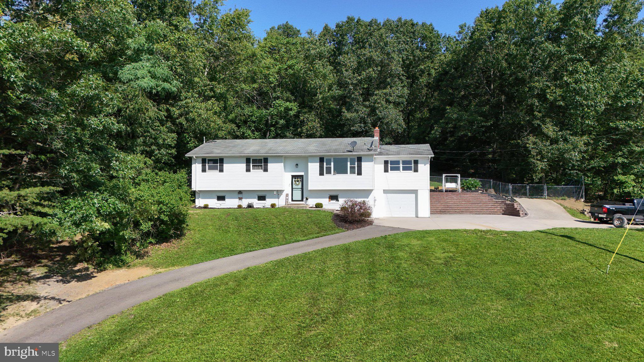 120 Motorcycle Lane Ridgeley, WV 26753 - Photo 2 of 34 a front view of a house with a yard and trees