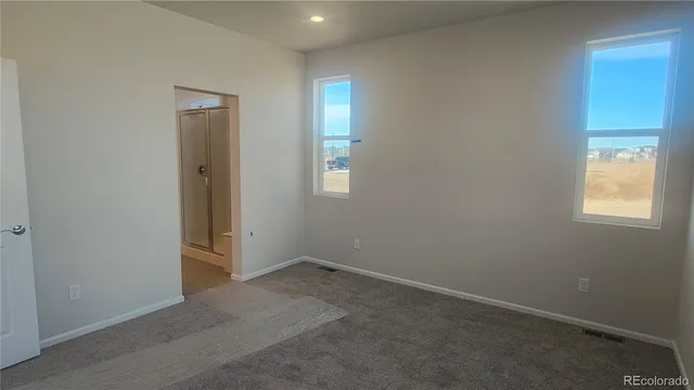 an empty room with windows and closet