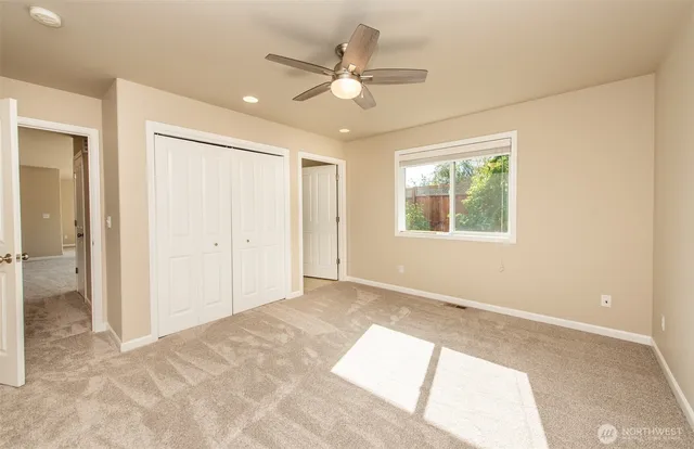 a view of a big room with wooden floor and windows in a room