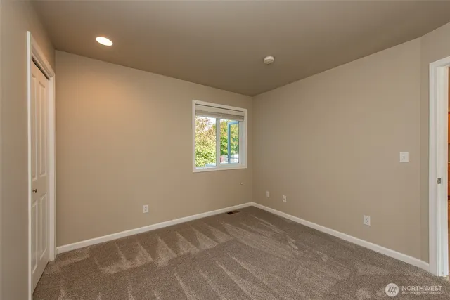 a backyard of a house with a bench