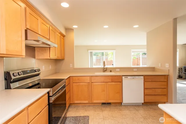 a kitchen with stainless steel appliances granite countertop a sink and cabinets