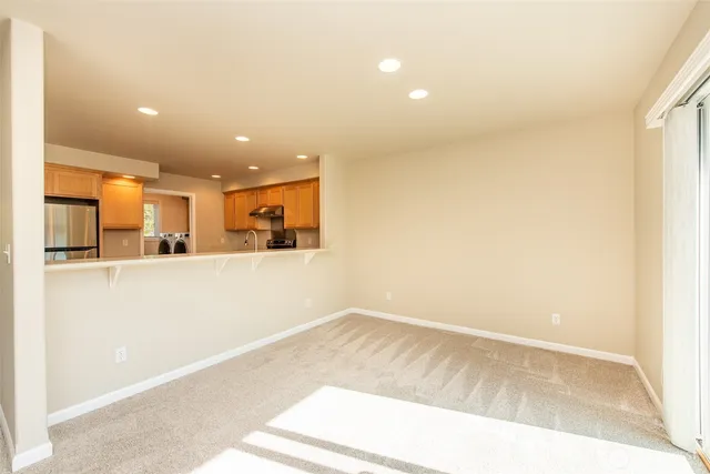 a view of a livingroom with wooden floor and a window