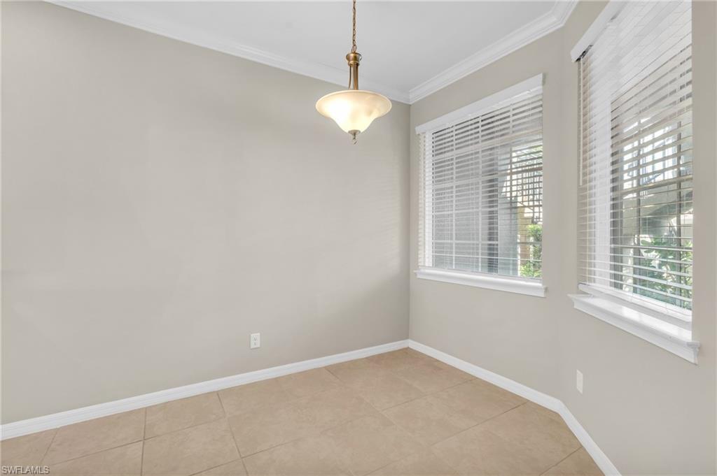 9385 Pocida Court, Unit 101 Naples, FL 34119 - Photo 12 of 26 a view of an empty room with a window