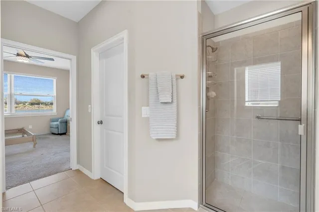 a bathroom with a granite countertop sink a mirror and a shower