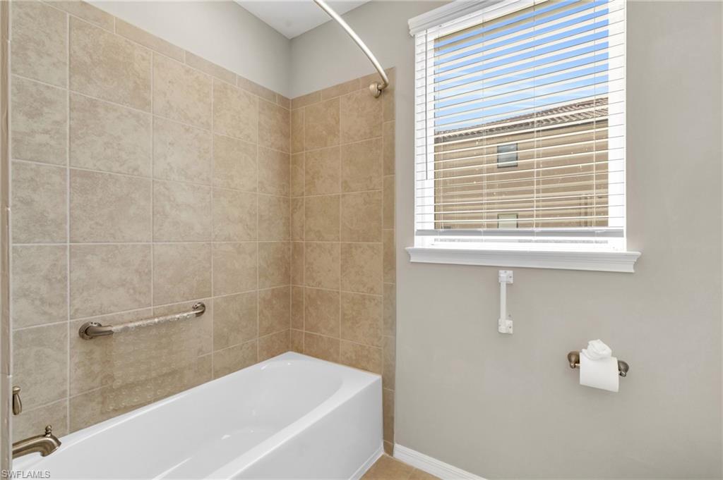 9385 Pocida Court, Unit 101 Naples, FL 34119 - Photo 20 of 26 a bathroom with a bathtub