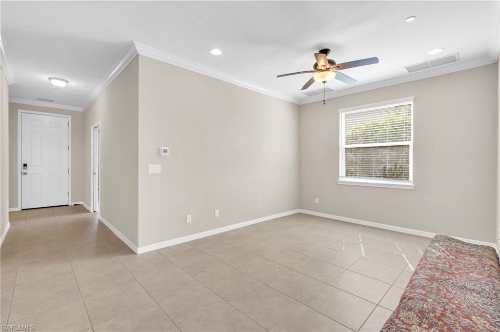 9385 Pocida Court, Unit 101 Naples, FL 34119 - Photo 4 of 26 a view of an empty room with a window