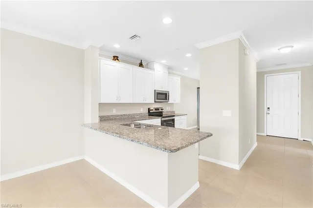 a kitchen with a refrigerator sink and cabinets