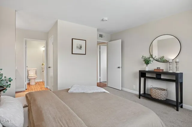 a bedroom with a bed and a potted plant