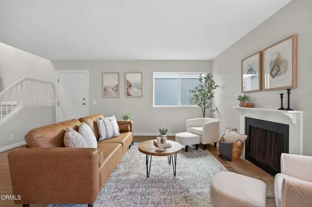 a living room with furniture and a potted plant