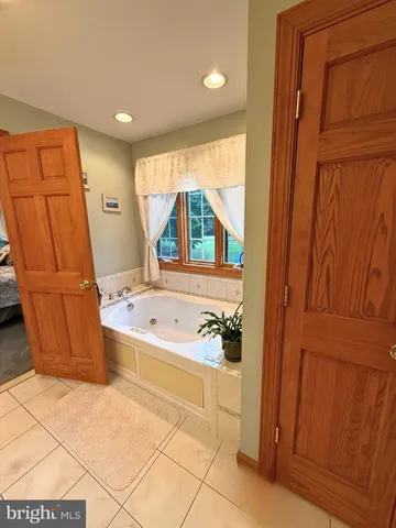a bathroom with a tub and a shower