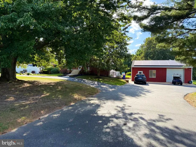 a view of a house with a yard and garage