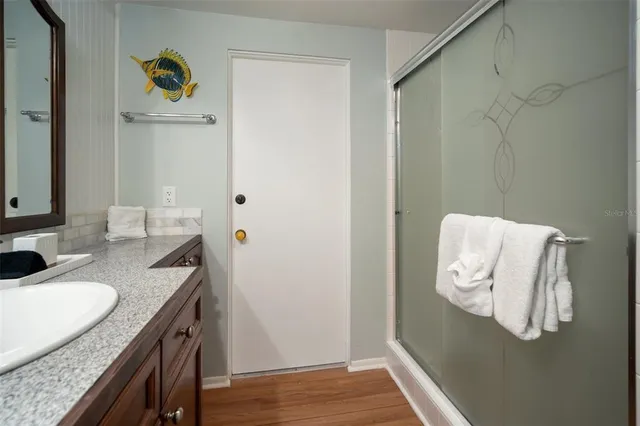 a kitchen with stainless steel appliances kitchen island granite countertop a table chairs sink and cabinets