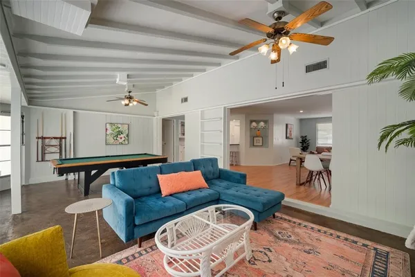 a bedroom with two beds and a chandelier