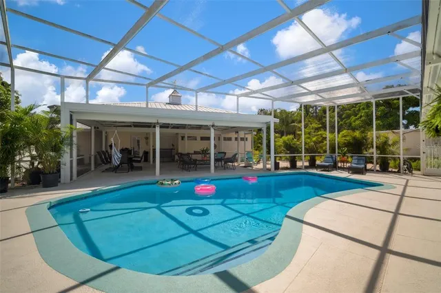 a bedroom with furniture and a large window