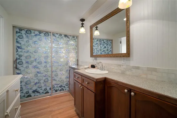 a kitchen with stainless steel appliances granite countertop a sink and a refrigerator