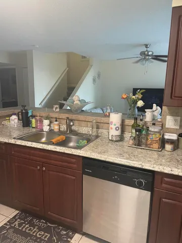 a kitchen with granite countertop a sink and cabinets