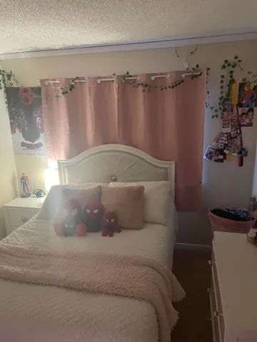 a bedroom with a bed and a dresser