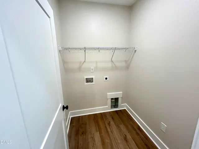 a view of walk in closet with wooden floor