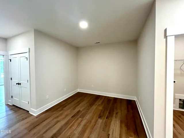 a view of a room with wooden floor