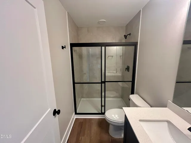 a white toilet sitting next to a bathroom sink