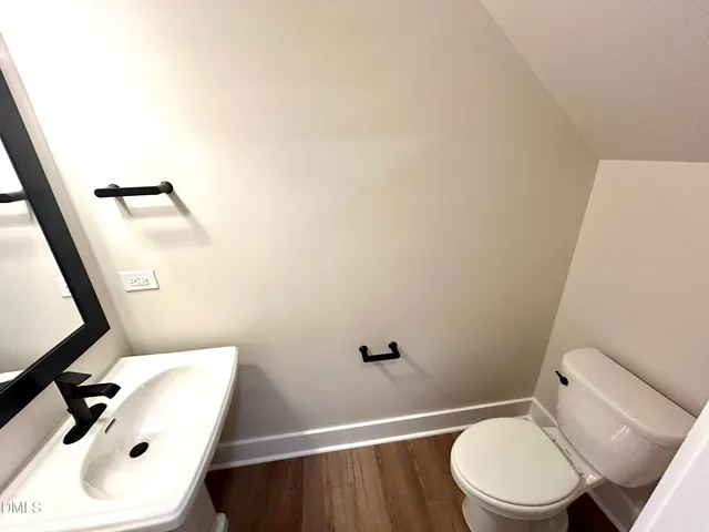 a bathroom with a sink a toilet and mirror
