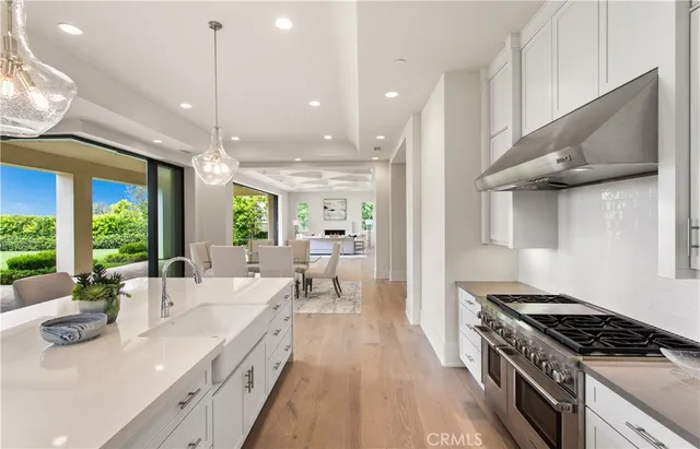 a living room with furniture a large window and a flat screen tv