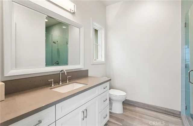 a kitchen with a stove and white cabinets