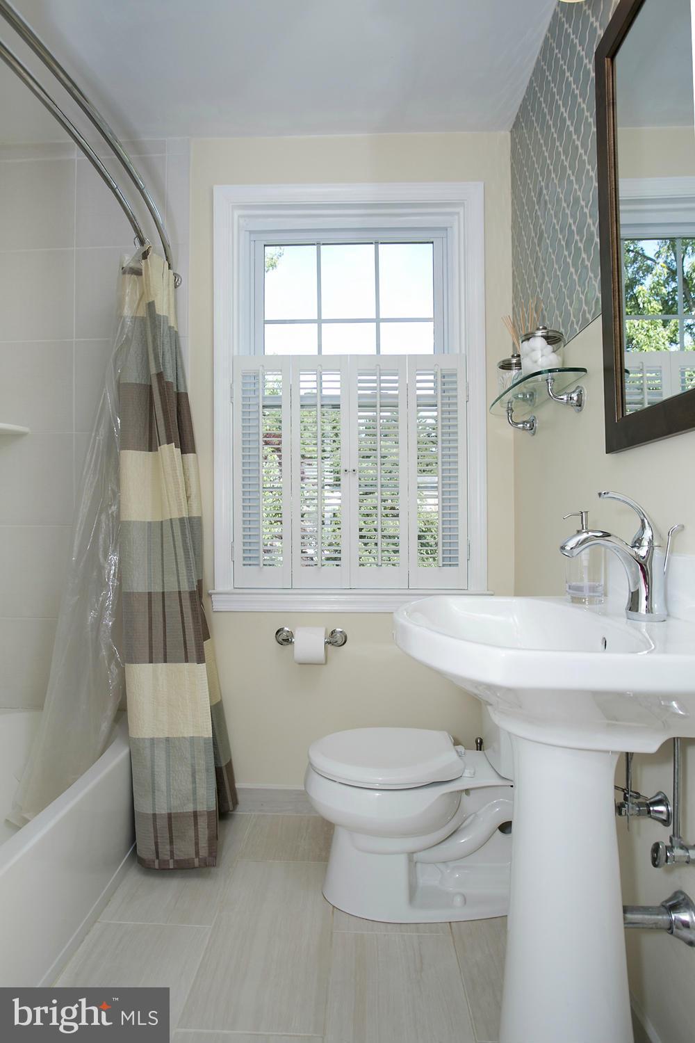 7047 Heathfield Road Baltimore, MD 21212 - Photo 9 of 19 a bathroom with a sink toilet and shower