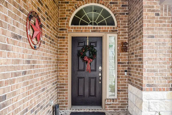 a view of a door with brick walls