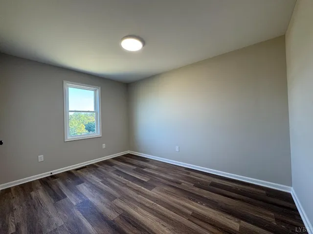 a view of room with window and hardwood floor
