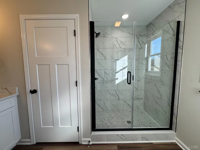 a view of a bathroom that has a glass shower door