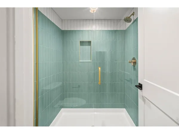 a bedroom with a bed and a lamp