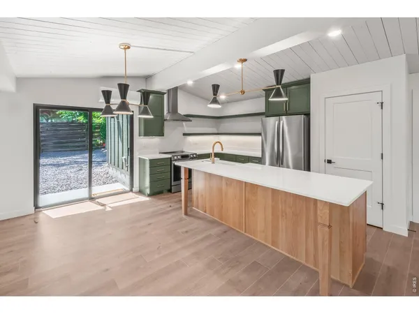 a kitchen with a sink and a refrigerator