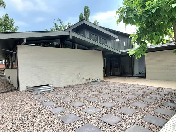 a front view of house with a garden