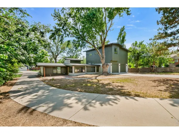 a backyard of a house with a yard and outdoor seating