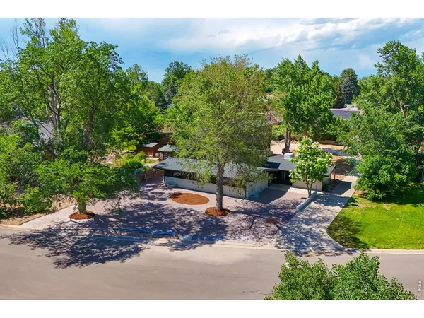 an aerial view of a house with a yard and lake view