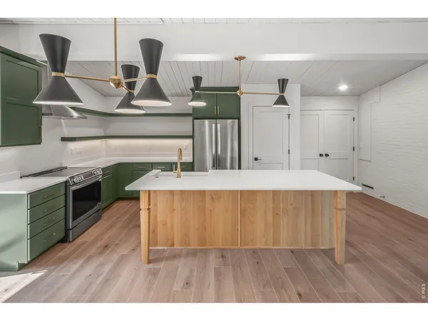 a kitchen with a sink and a refrigerator