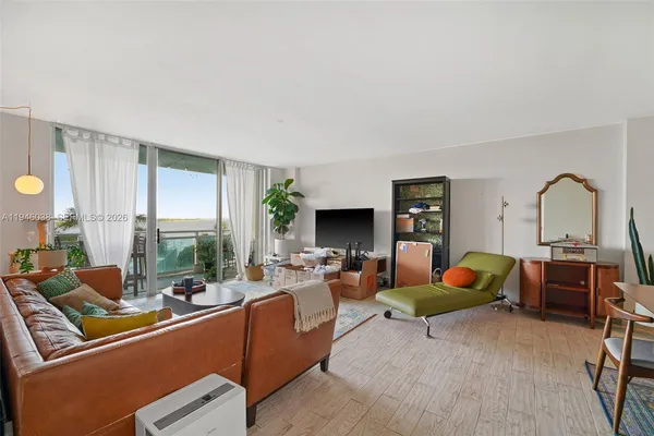 a living room with furniture fireplace and a table