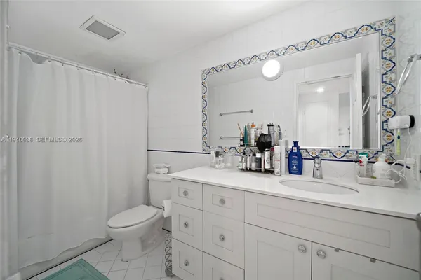 a bathroom with a toilet a sink and a mirror