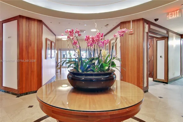 a view of a living room with a fountain and a potted plant