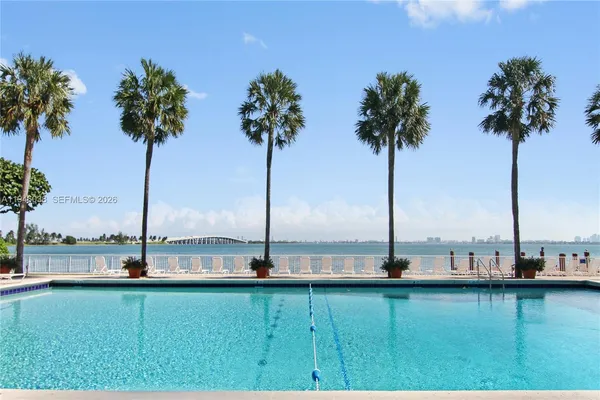 a view of lake with palm trees