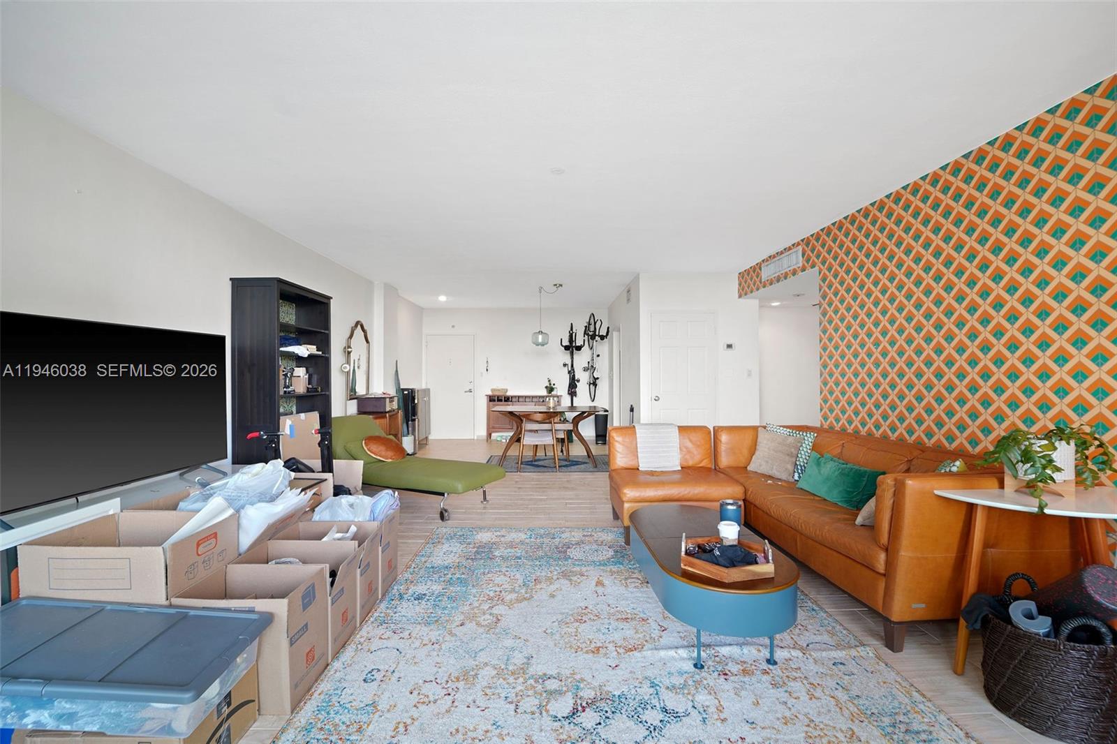 3301 Northeast 5th Avenue, Unit 416 Miami, FL 33137 - Photo 6 of 23 a living room with furniture and a lamp