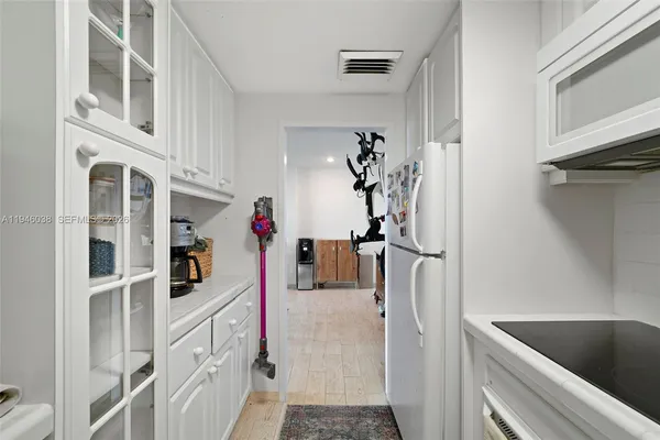 a kitchen with cabinets and refrigerator