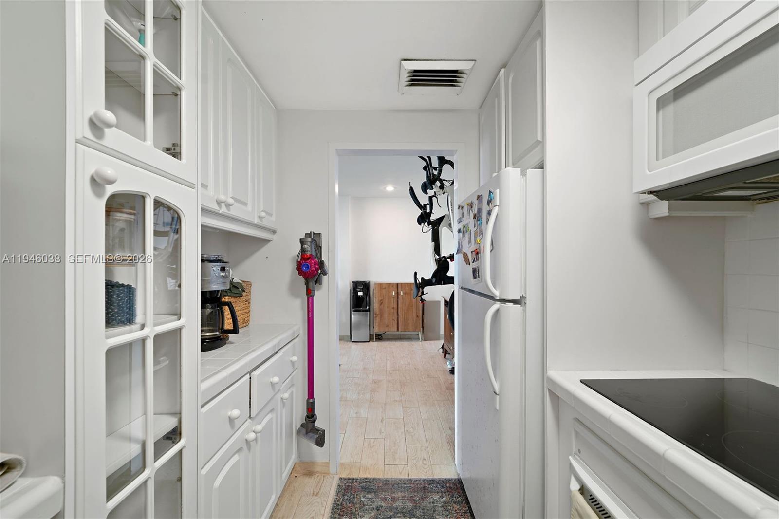 3301 Northeast 5th Avenue, Unit 416 Miami, FL 33137 - Photo 9 of 23 a kitchen with cabinets and refrigerator