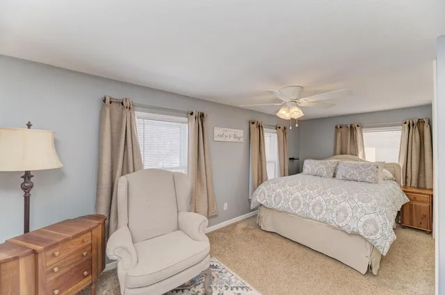 a spacious bedroom with a bed and a couch