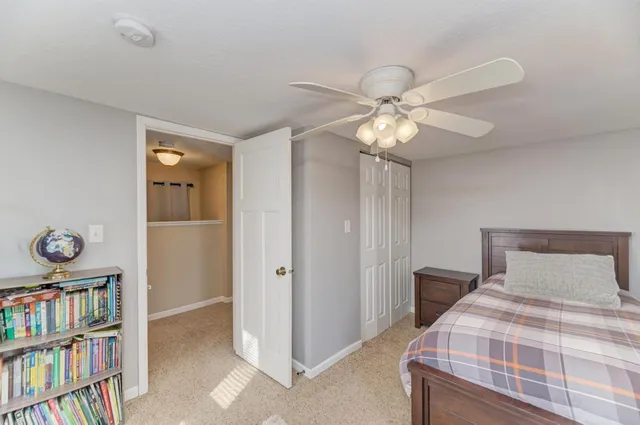 a bedroom with a bed and a book shelf